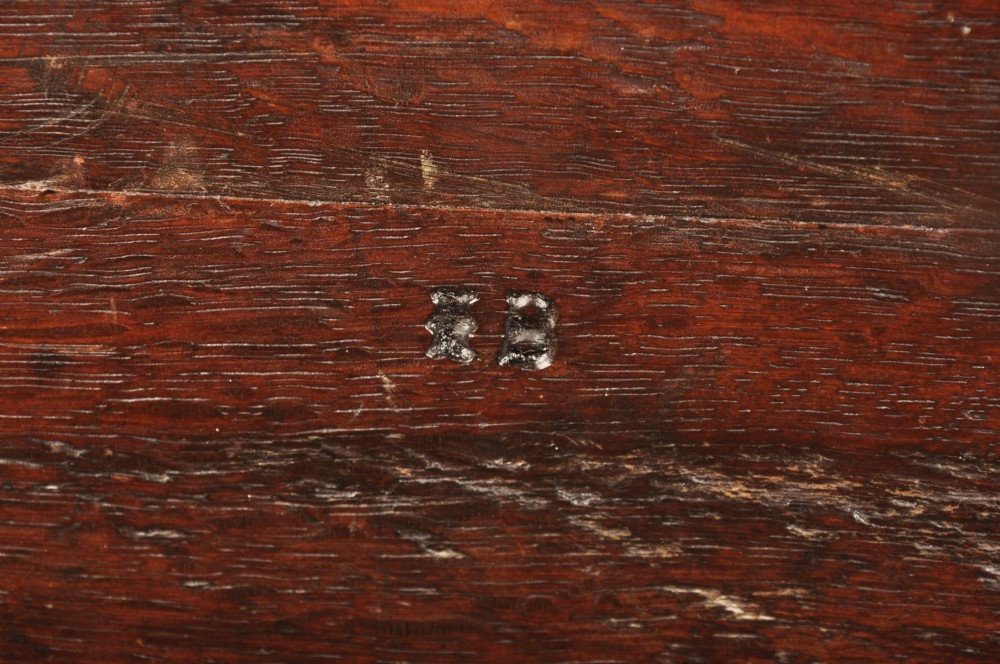 A 17th-century dark oak wainscot armchair featuring a carved lozenge back panel, turned front supports, and shaped armrests. View XI
