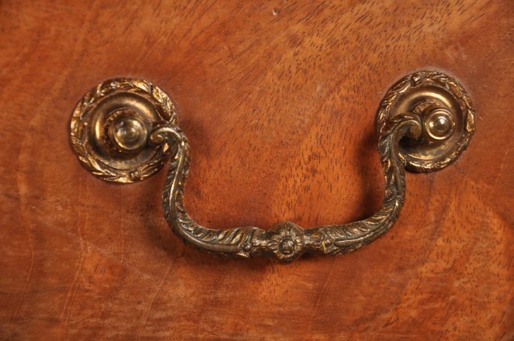An 18th-century Georgian mahogany tallboy chest-on-chest with flame mahogany drawer fronts, brass swan-neck handles, fluted quarter columns, and bracket feet. View VI