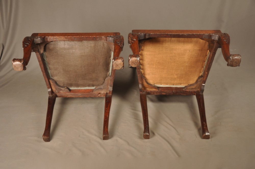 A pair of 18th-century George II mahogany side chairs featuring pierced carved splats, cabriole legs with claw and ball feet, and floral needlepoint drop-in seats. View IX