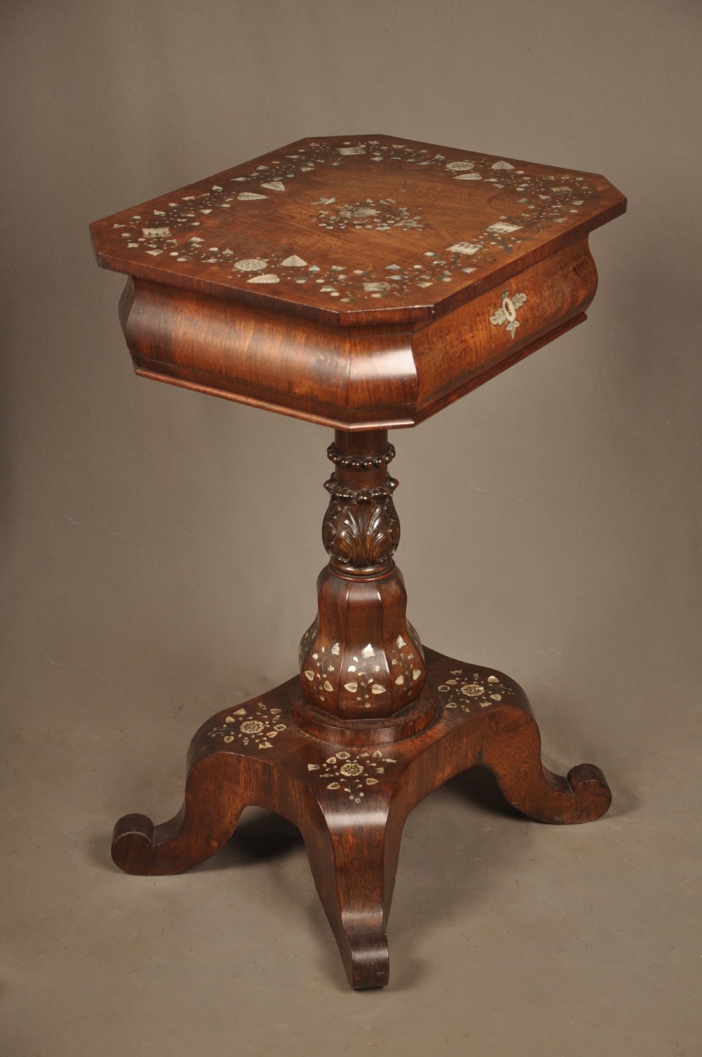 An antique octagonal mahogany work table with mother-of-pearl floral inlay, a central carved pedestal, and a quadruped base. View III