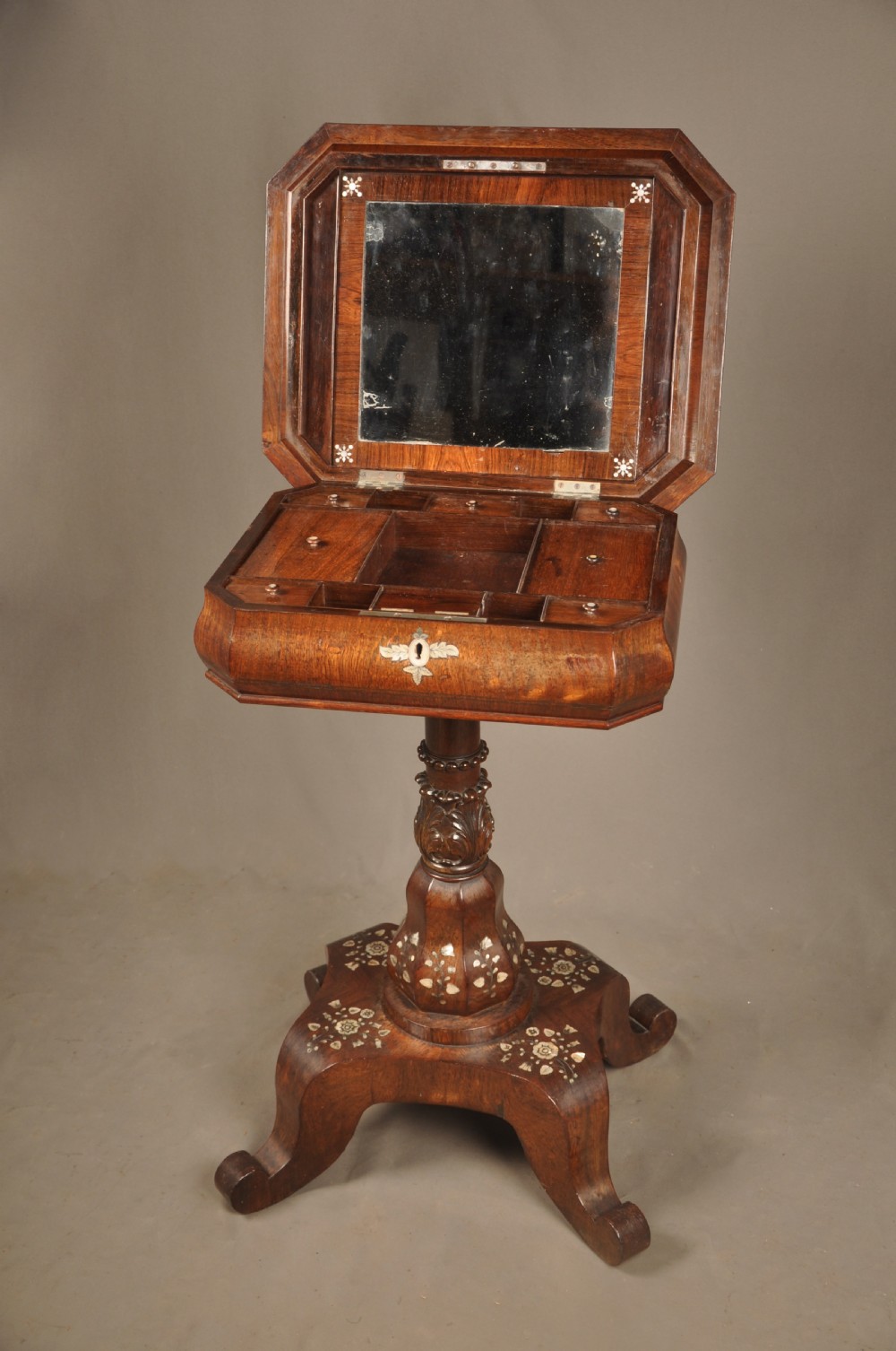An antique octagonal mahogany work table with mother-of-pearl floral inlay, a central carved pedestal, and a quadruped base. View IV