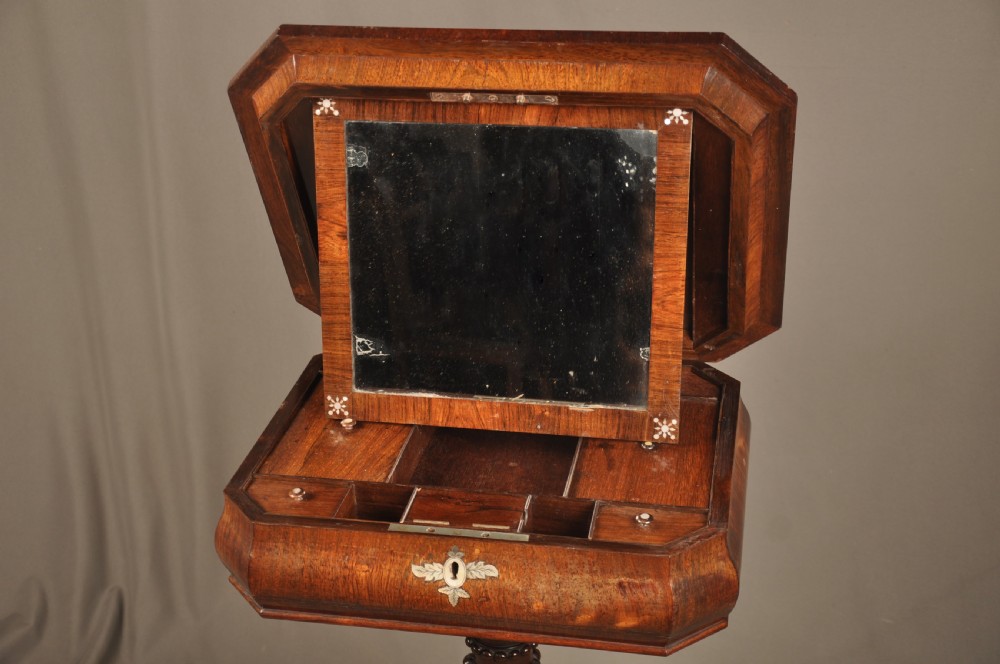 An antique octagonal mahogany work table with mother-of-pearl floral inlay, a central carved pedestal, and a quadruped base. View V