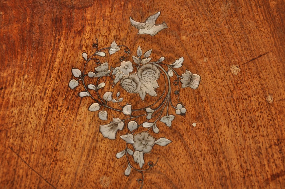 An antique octagonal mahogany work table with mother-of-pearl floral inlay, a central carved pedestal, and a quadruped base. View X