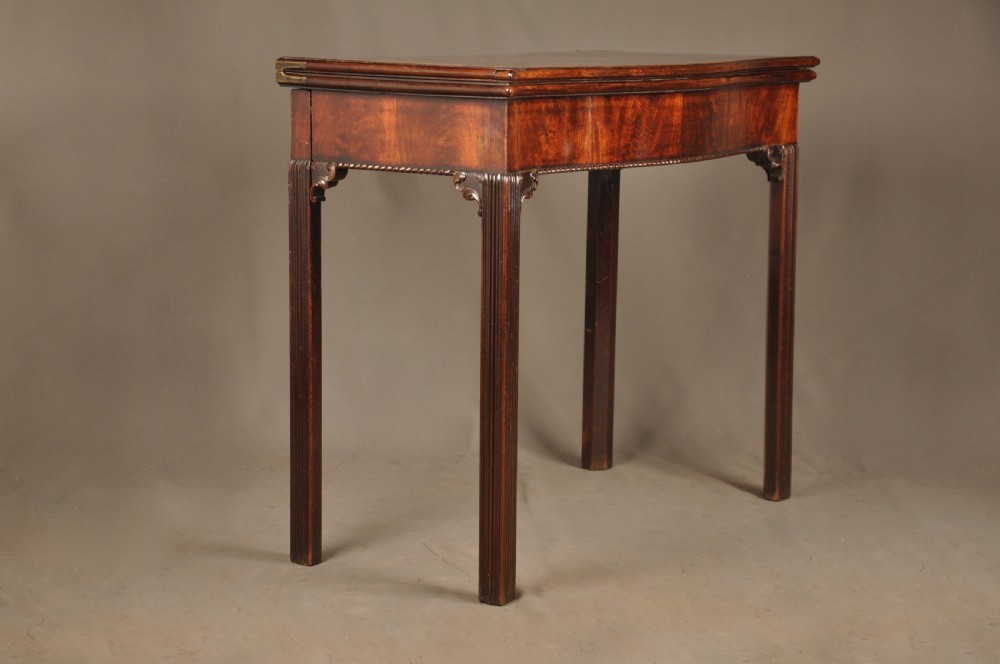 An 18th-century Georgian mahogany card table with a folded serpentine top and fluted legs. View III