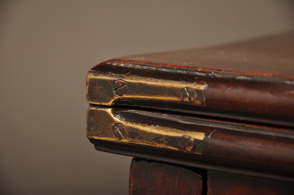 An 18th-century Georgian mahogany card table with a folded serpentine top and fluted legs. View IX