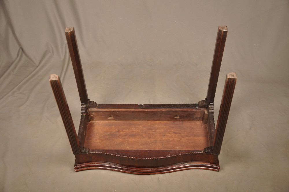 An 18th-century Georgian mahogany card table with a folded serpentine top and fluted legs. View XI