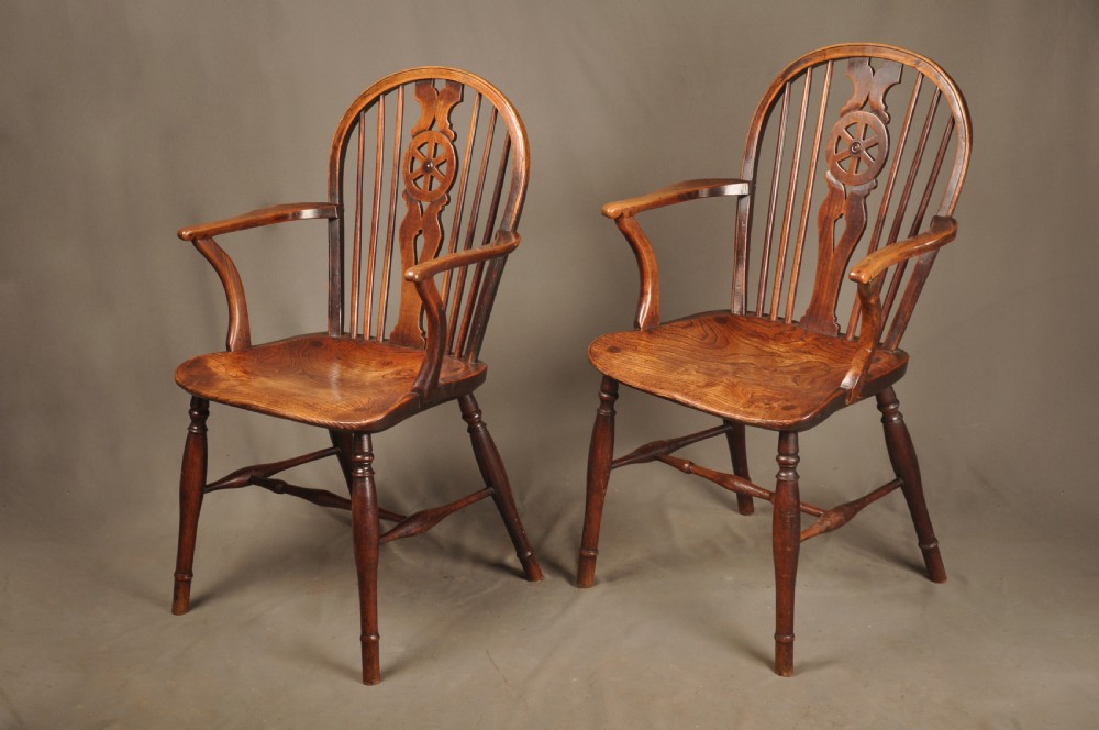 A pair of late 18th-century elm wheelback Windsor armchairs featuring curved backrests with pierced wheel splats, shaped seats, turned legs, and H-stretchers. View II