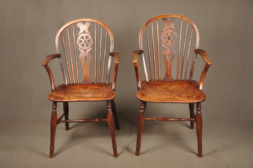 A pair of late 18th-century elm wheelback Windsor armchairs featuring curved backrests with pierced wheel splats, shaped seats, turned legs, and H-stretchers. View III