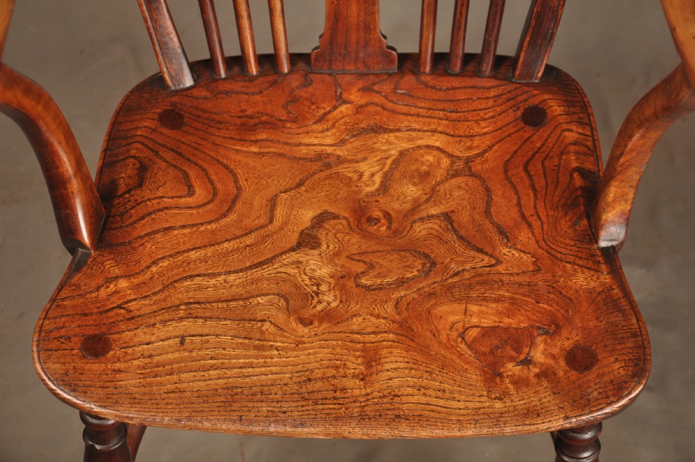 A pair of late 18th-century elm wheelback Windsor armchairs featuring curved backrests with pierced wheel splats, shaped seats, turned legs, and H-stretchers. View IX