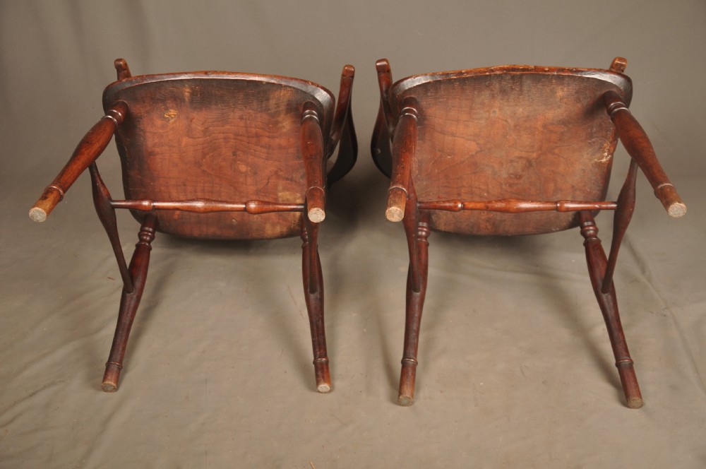 A pair of late 18th-century elm wheelback Windsor armchairs featuring curved backrests with pierced wheel splats, shaped seats, turned legs, and H-stretchers. View X