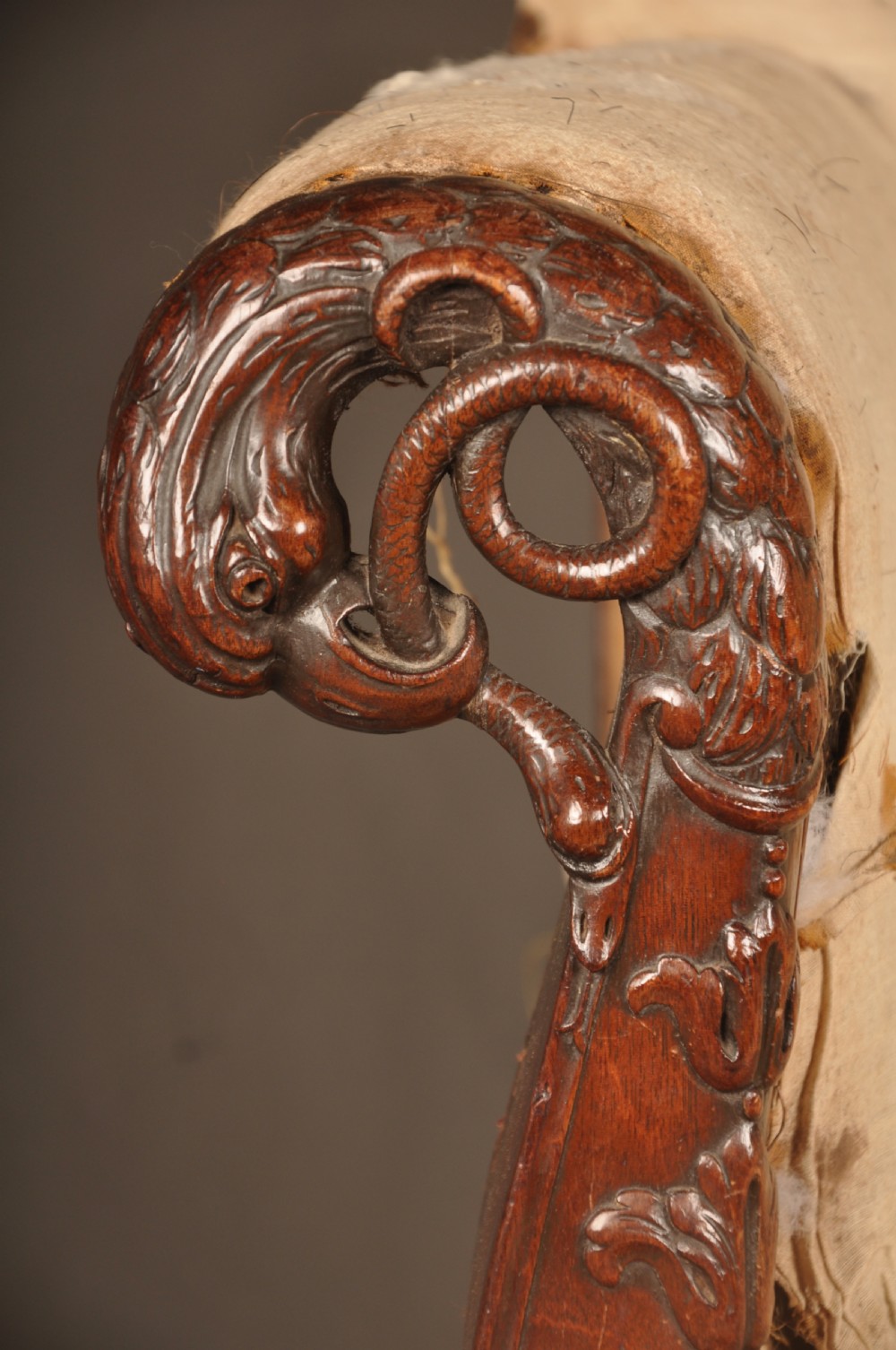 A 19th-century carved mahogany library armchair in calico lining, featuring cabriole legs with claw and ball feet and scrolled armrests. View II