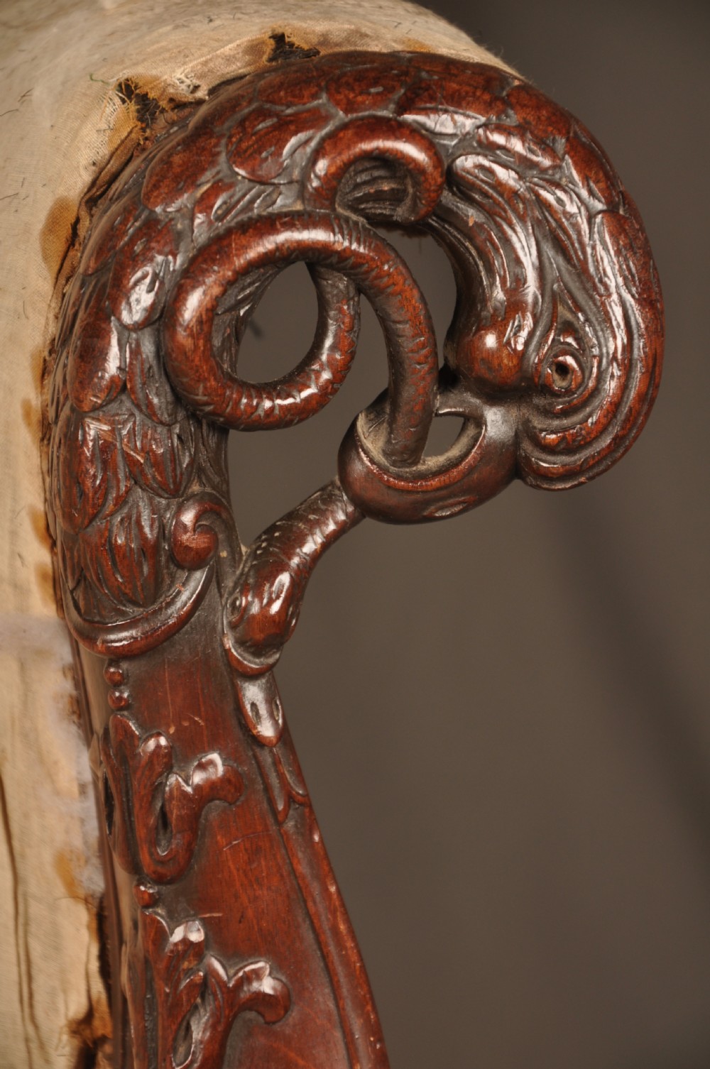 A 19th-century carved mahogany library armchair in calico lining, featuring cabriole legs with claw and ball feet and scrolled armrests. View IV