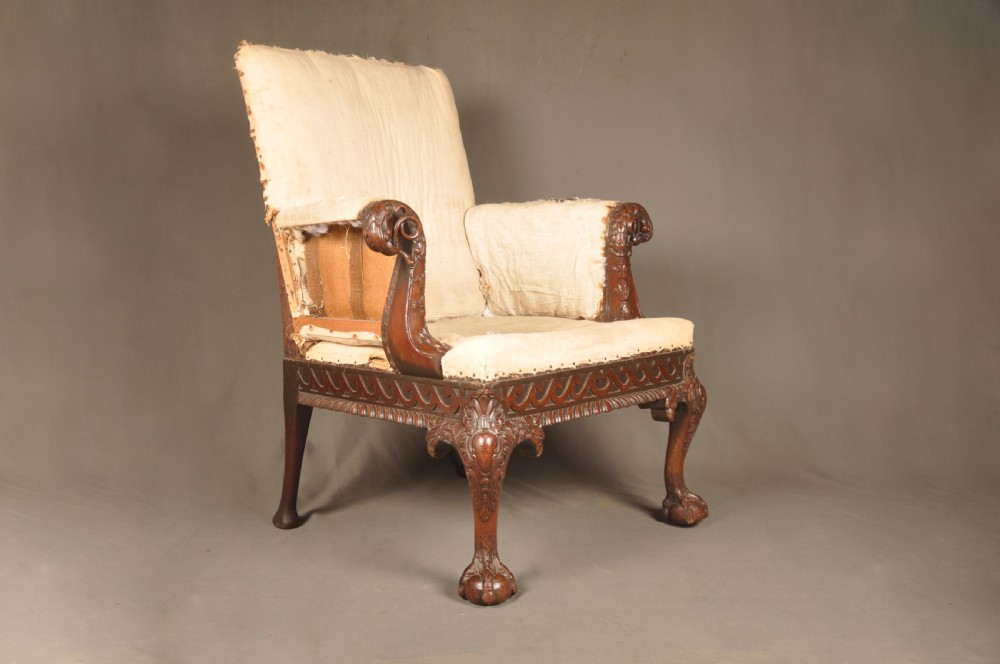 A 19th-century carved mahogany library armchair in calico lining, featuring cabriole legs with claw and ball feet and scrolled armrests. View VII