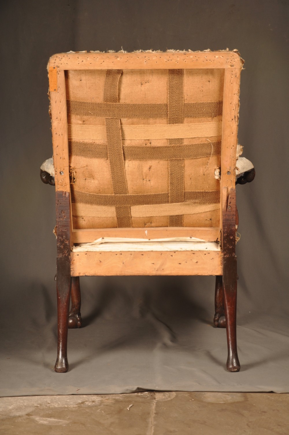 A 19th-century carved mahogany library armchair in calico lining, featuring cabriole legs with claw and ball feet and scrolled armrests. View XI