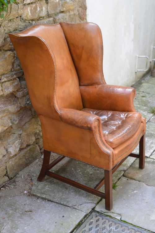 a large george iii style tan leather wingback armchair - CATEGORY: ANTIQUE CHAIRS - DATED 1930