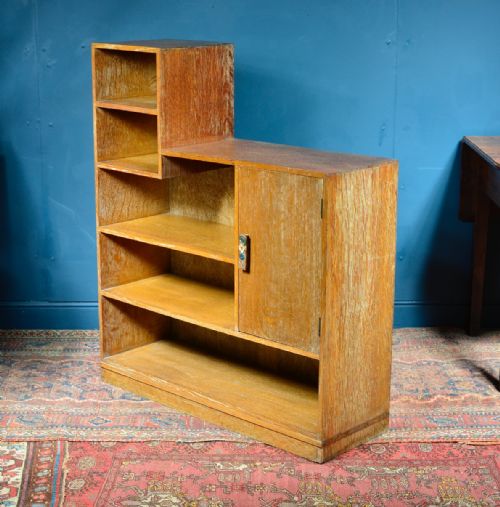a limed oak asymmetrical open bookcase attributed to heal's c1930 - CATEGORY: ANTIQUE CABINETS - DATED 1930