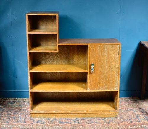 A LIMED OAK ASYMMETRICAL OPEN BOOKCASE ATTRIBUTED TO HEAL'S C1930 - ADDITIONAL PHOTO 1