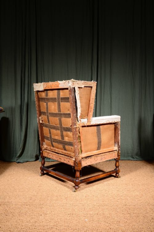 AN EDWARDIAN MAHOGANY ANGULAR WINGBACK ARMCHAIR STRIPPED FOR REUPHOLSTERY C1910 - ADDITIONAL PHOTO 1