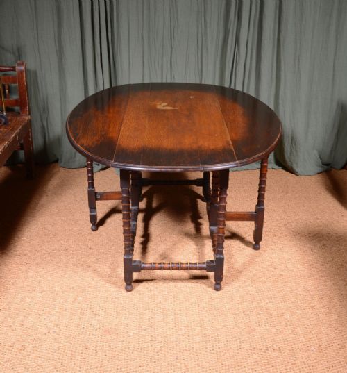 AN OAK OVAL DROP LEAF DINING TABLE ON BOBBIN LEGS C1890 - ADDITIONAL PHOTO 1