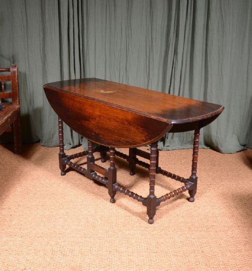 AN OAK OVAL DROP LEAF DINING TABLE ON BOBBIN LEGS C1890 - ADDITIONAL PHOTO 5