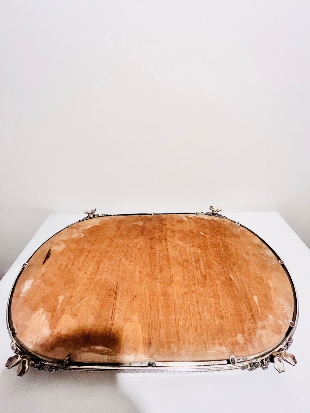 An antique late Victorian silver-plated table plateau featuring an oval mirrored surface enclosed by a pierced gallery rim and resting on cast feet. View VI