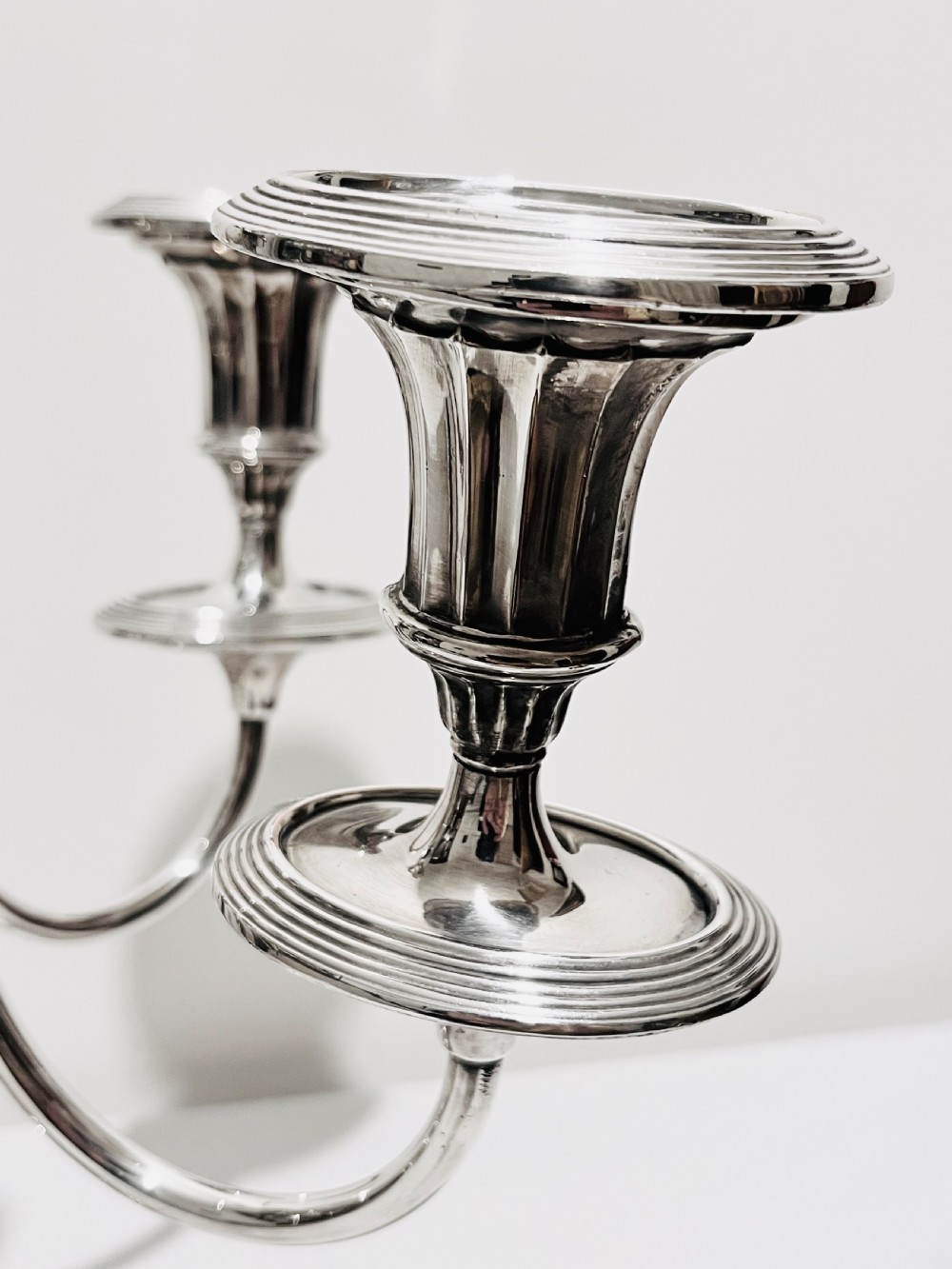 An antique silver-plated five-light candelabra featuring a central lyre-shaped stem with five scrolling branches terminating in circular candle nozzles. View V