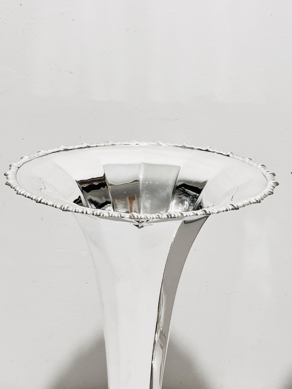 A pair of tall silver-plated trumpet vases featuring flared fluted rims, beaded border trims, and stepped circular bases. View III