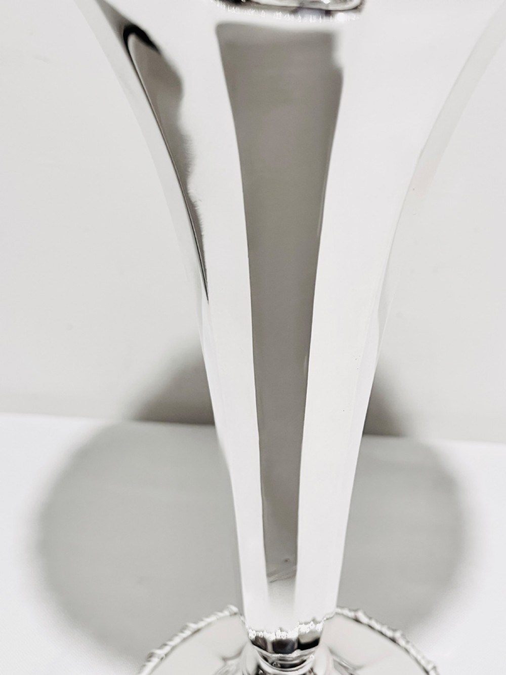 A pair of tall silver-plated trumpet vases featuring flared fluted rims, beaded border trims, and stepped circular bases. View VI