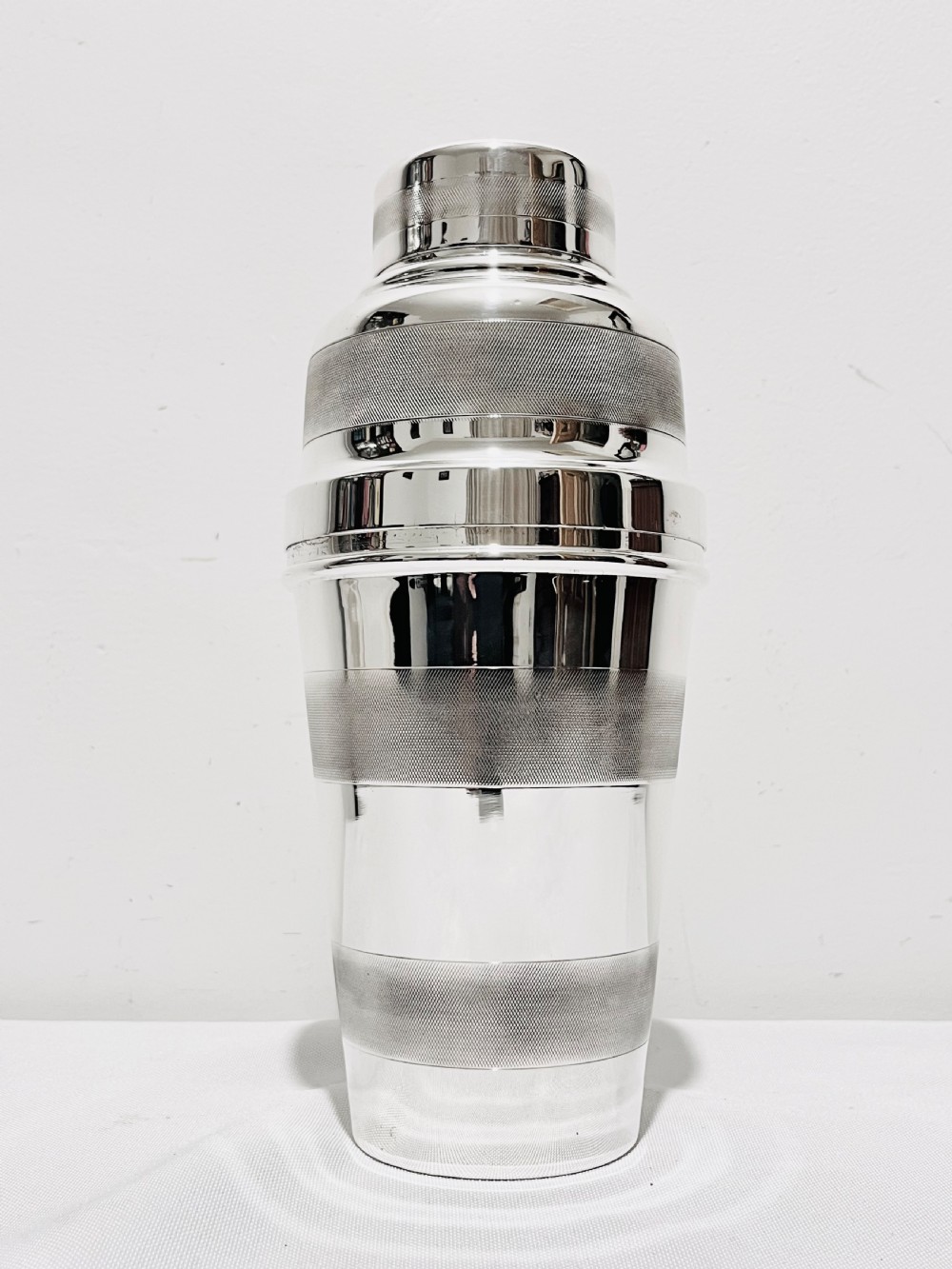 Engine turned silver plated cocktail shaker  with lemon squeezer c1940