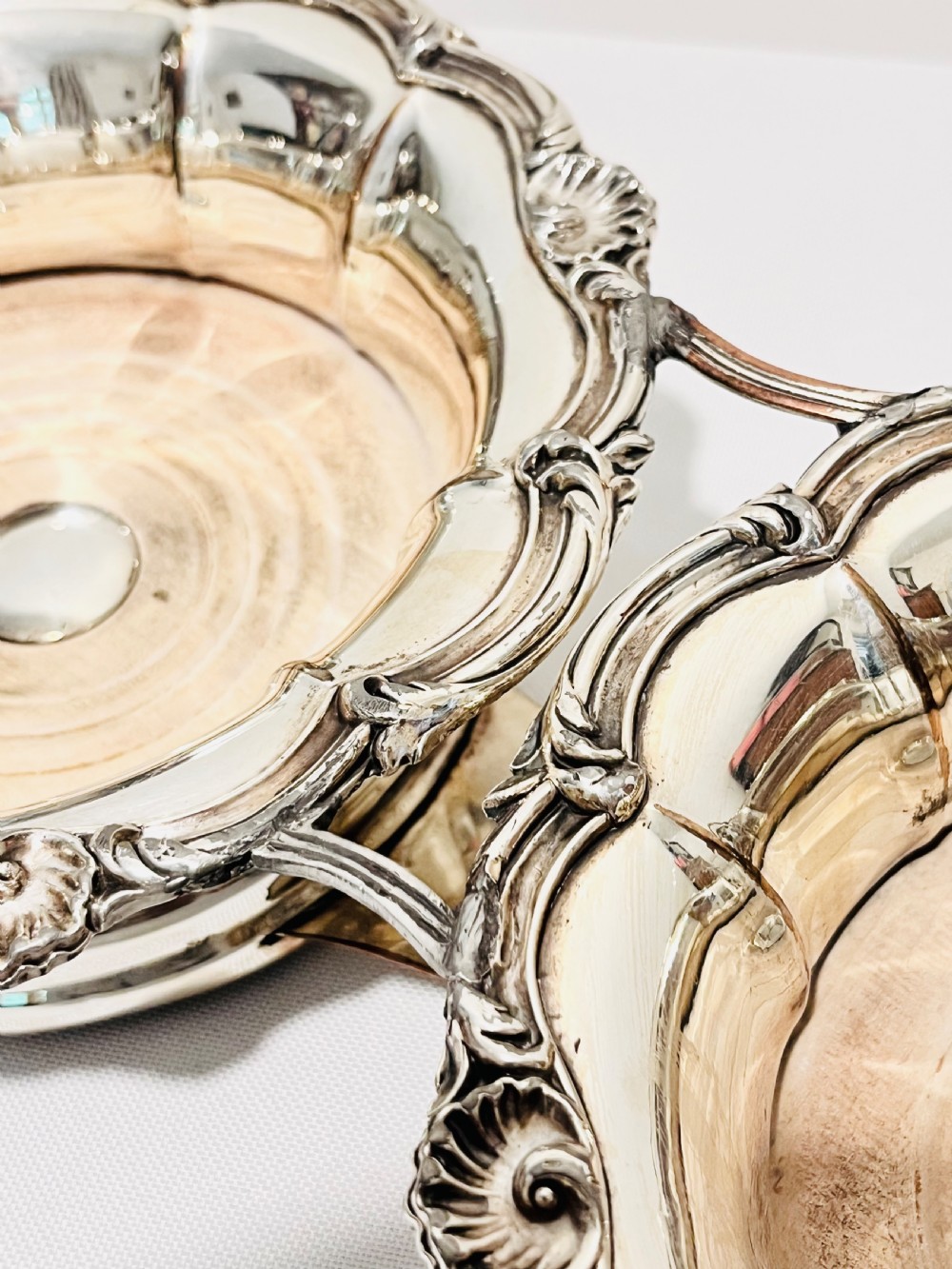 An antique Old Sheffield silver plate double wine decanter trolley with shell and scroll borders and turned wooden inserts. View V