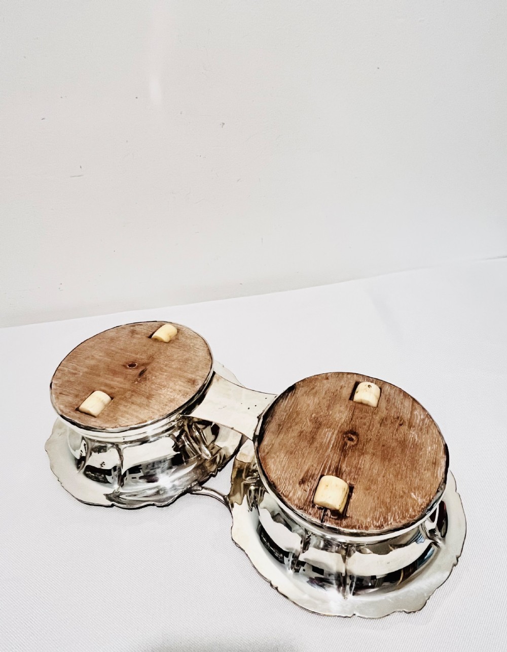 An antique Old Sheffield silver plate double wine decanter trolley with shell and scroll borders and turned wooden inserts. View VI