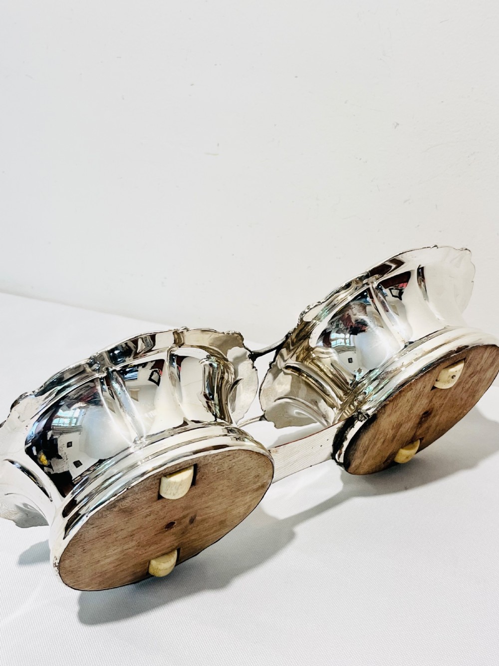 An antique Old Sheffield silver plate double wine decanter trolley with shell and scroll borders and turned wooden inserts. View VII