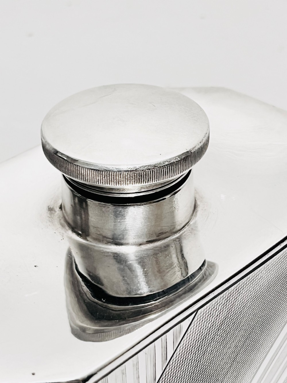An Art Deco silver-plated giant spirit flask featuring geometric engine-turned pattern work and a cylindrical screw cap. View IV