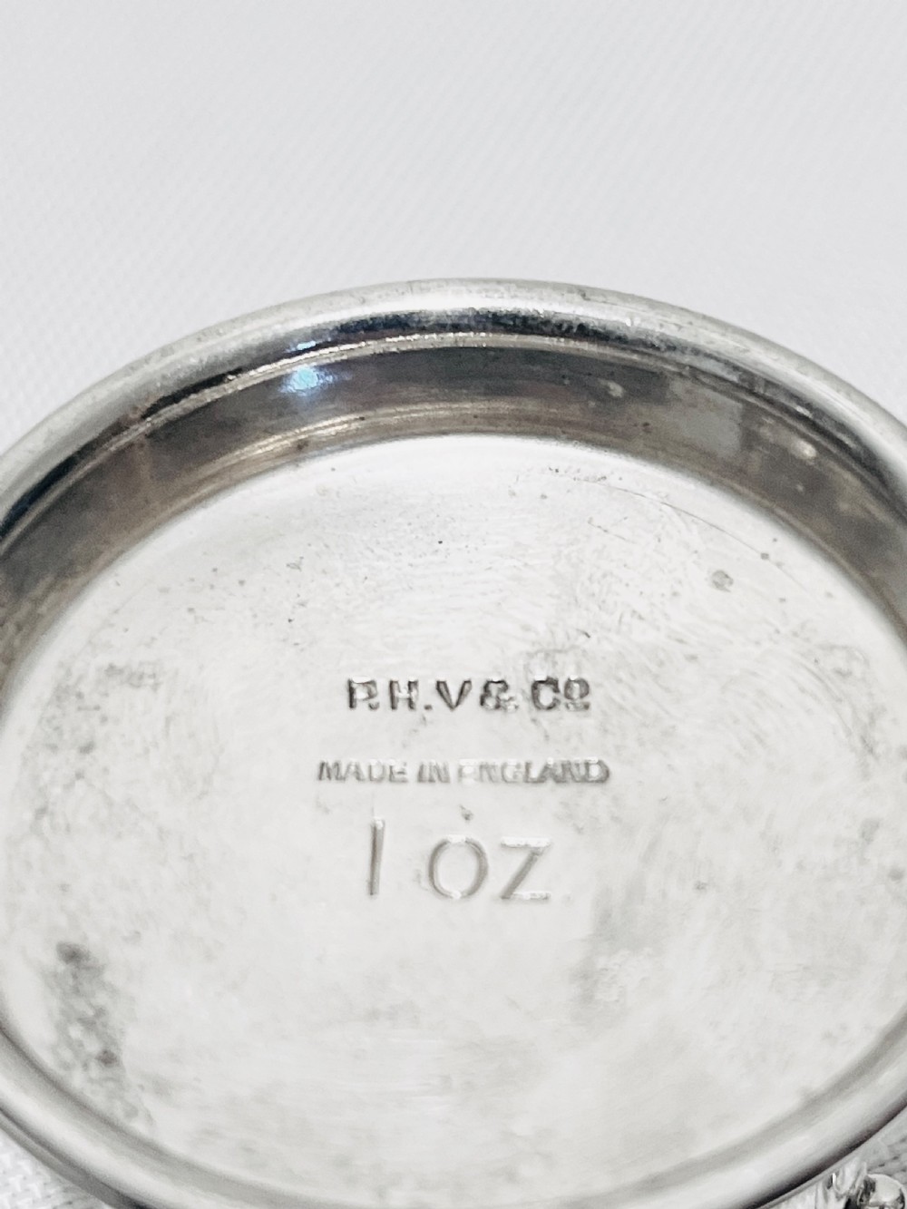 An Art Deco silver-plated bar set featuring miniature tankards, red-handled tools, and cherry cocktail picks arranged on a circular stand with a pale onyx base. View VI