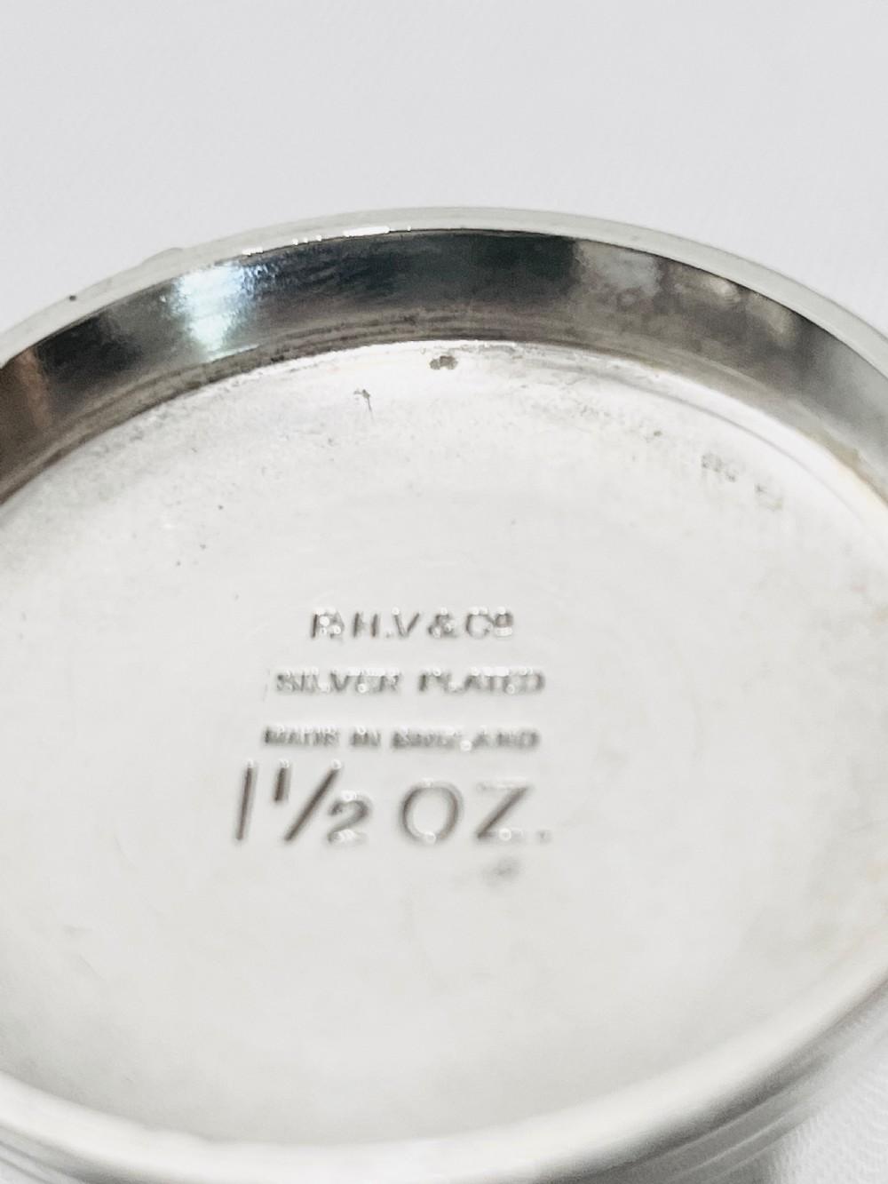 An Art Deco silver-plated bar set featuring miniature tankards, red-handled tools, and cherry cocktail picks arranged on a circular stand with a pale onyx base. View VII