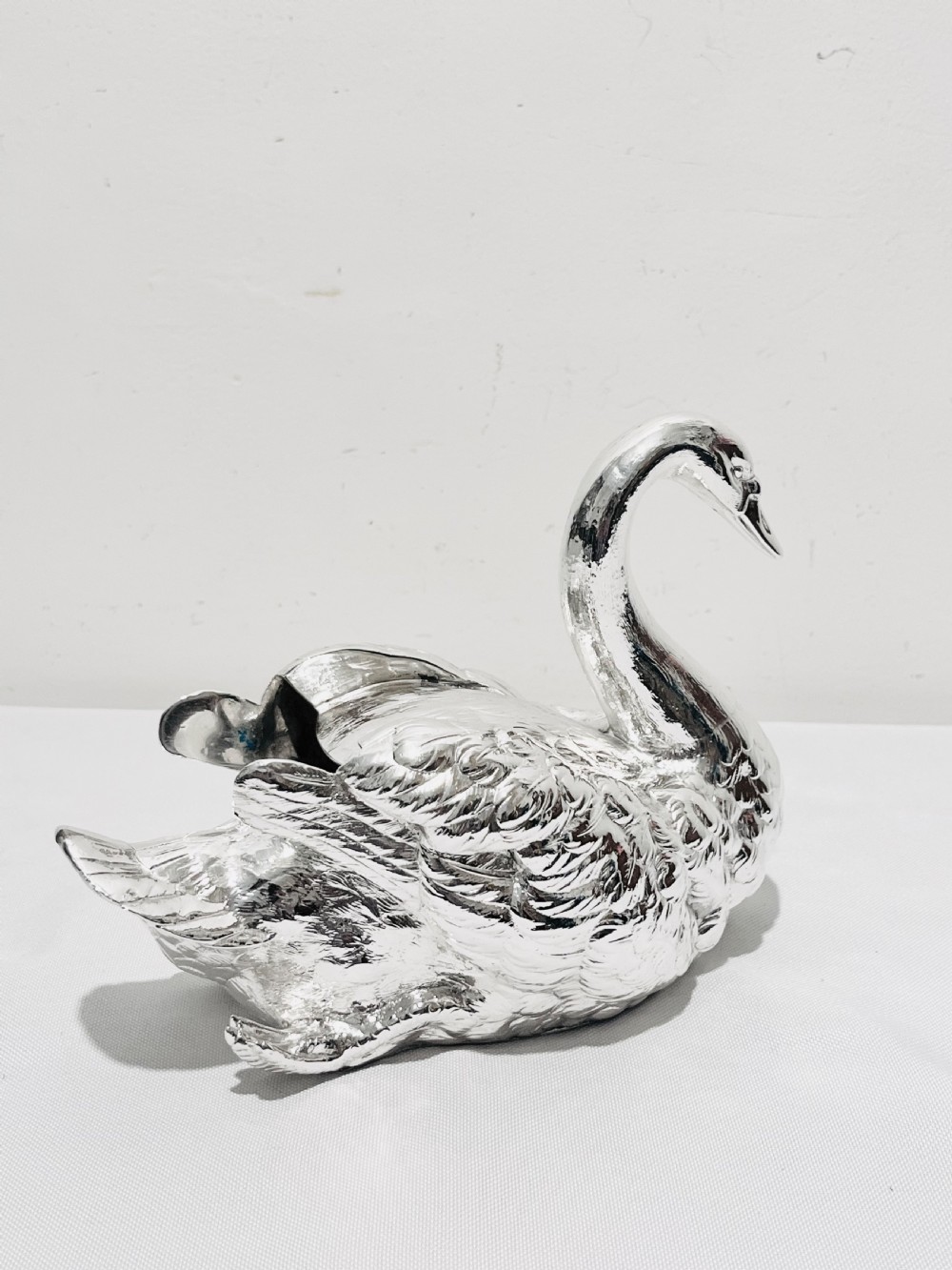 An antique silver-plated novelty spoon warmer cast in the detailed shape of a resting swan. View III