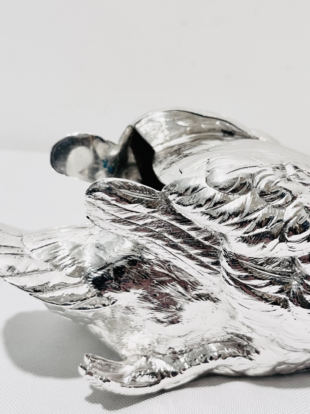An antique silver-plated novelty spoon warmer cast in the detailed shape of a resting swan. View VI