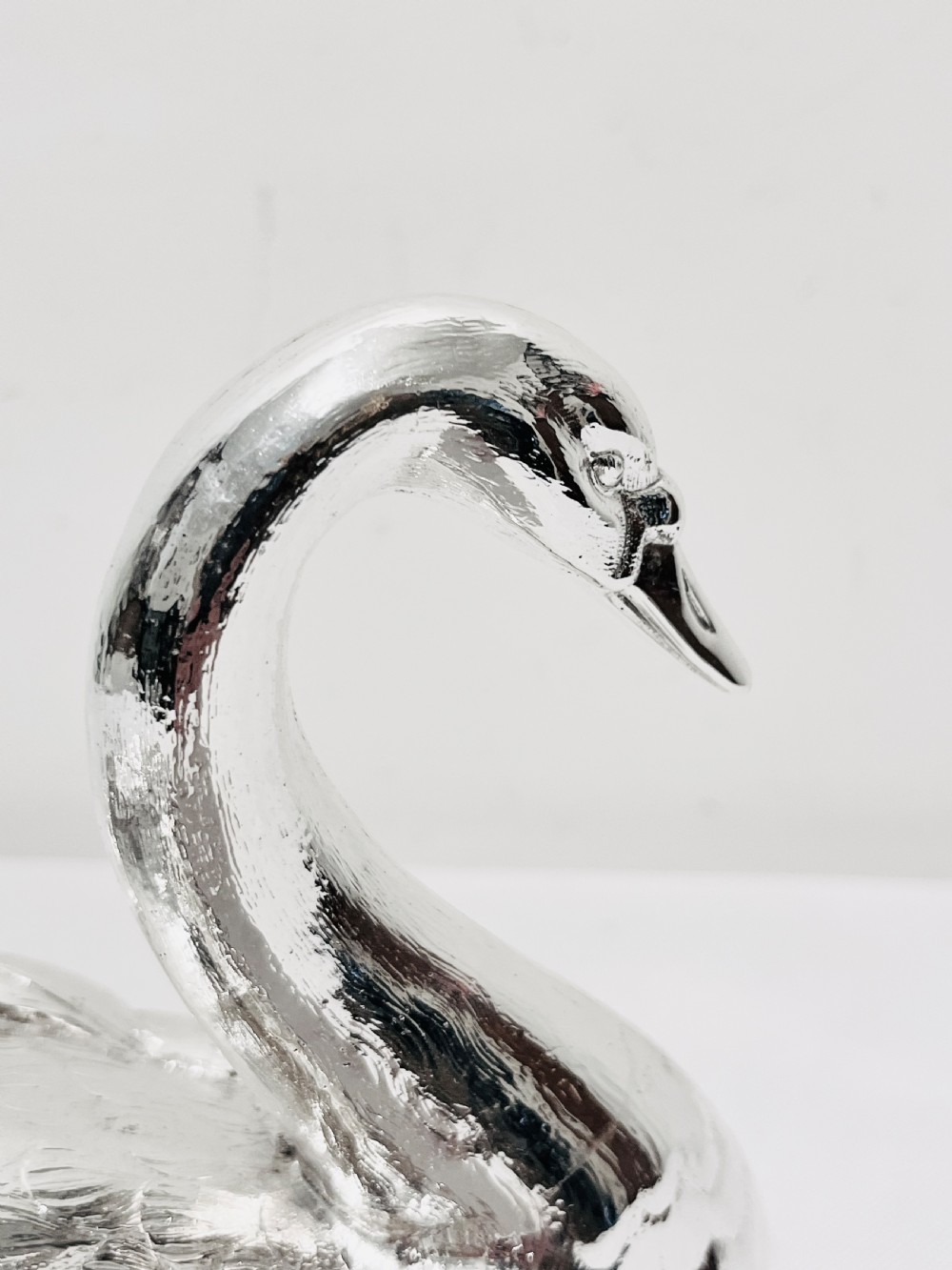 An antique silver-plated novelty spoon warmer cast in the detailed shape of a resting swan. View VII
