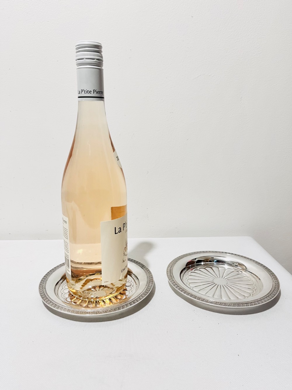 A pair of circular French silver-plated wine coasters featuring fluted central wells and detailed outer rims. View II