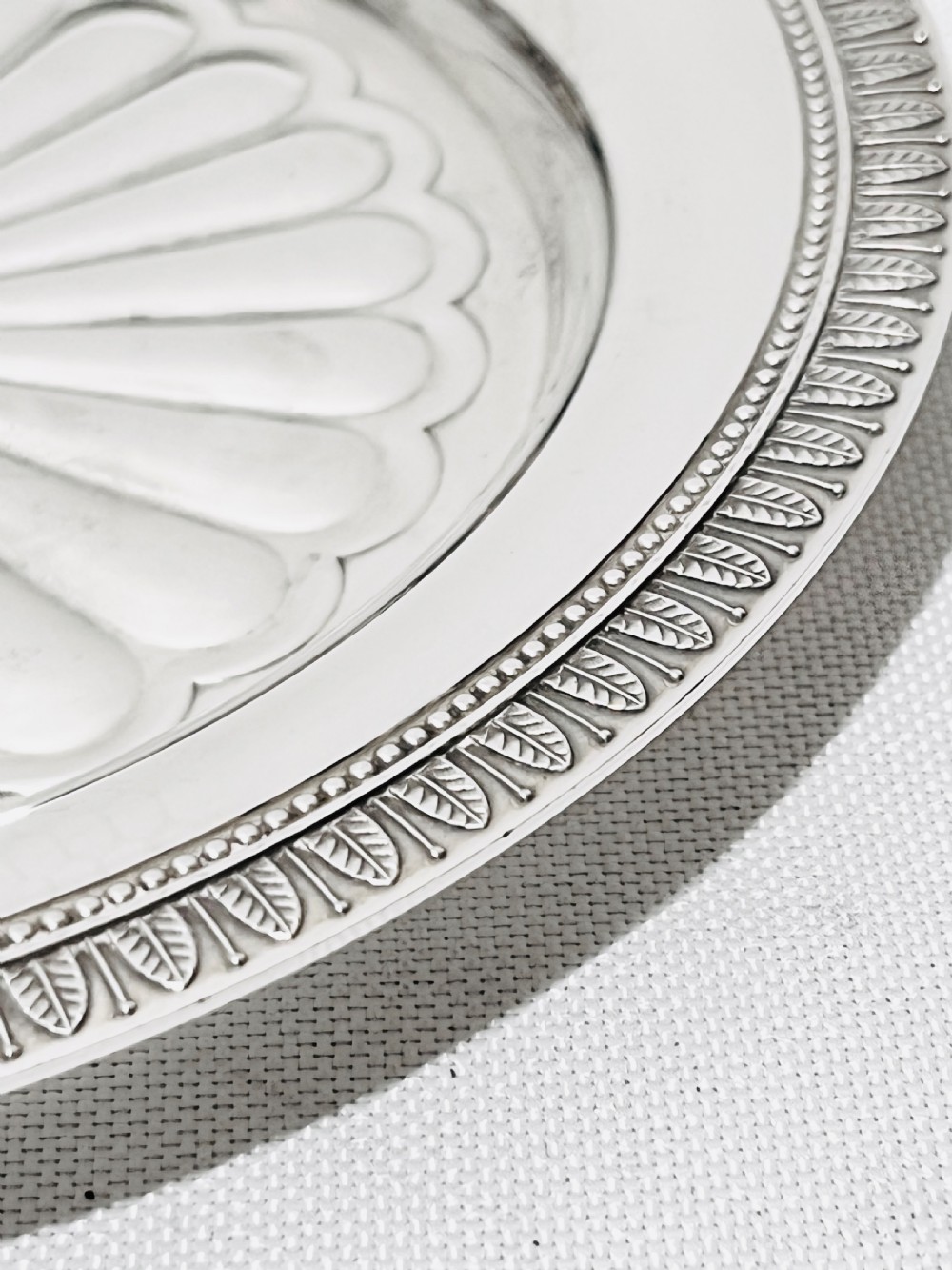 A pair of circular French silver-plated wine coasters featuring fluted central wells and detailed outer rims. View VI