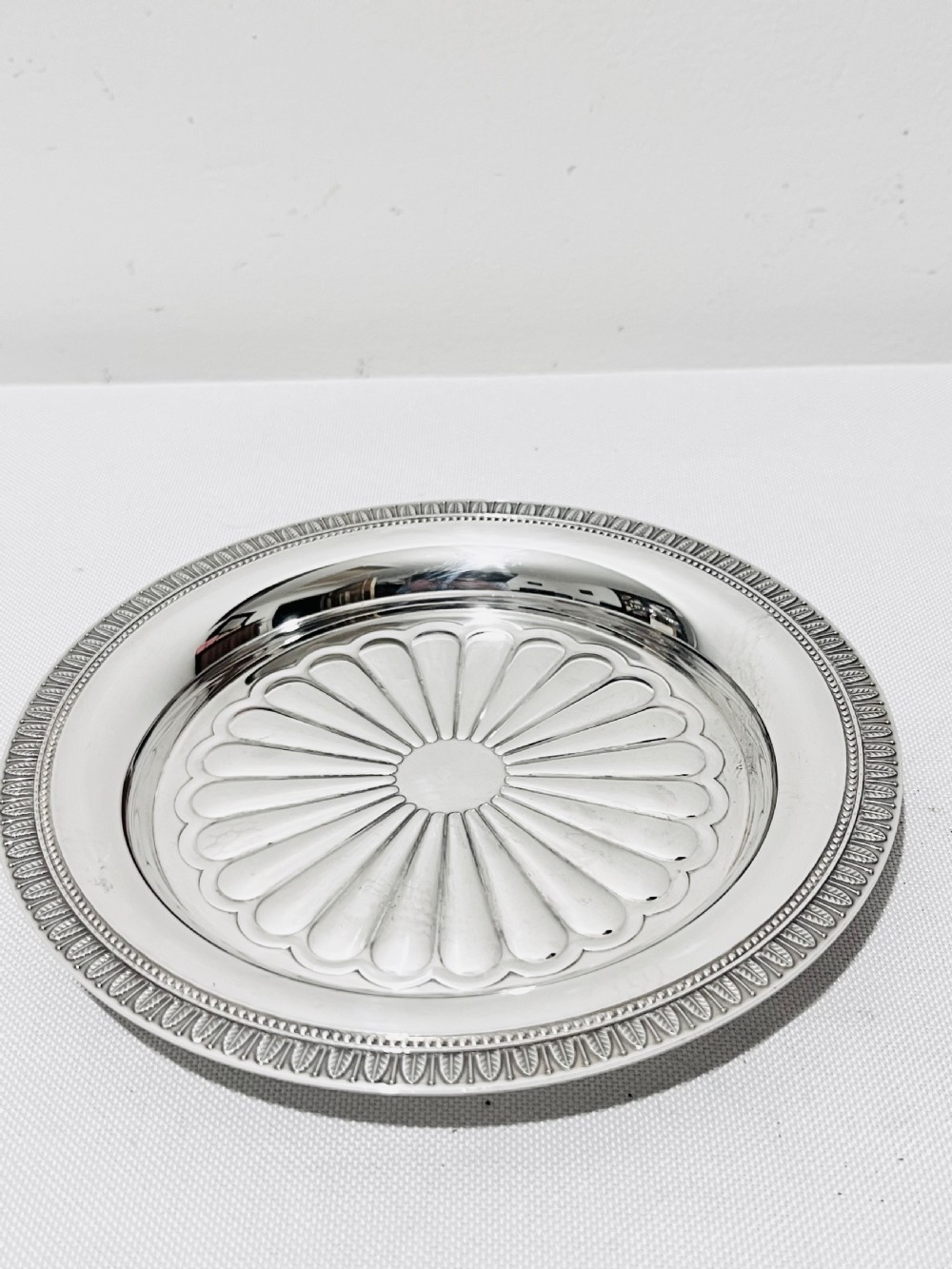 A pair of circular French silver-plated wine coasters featuring fluted central wells and detailed outer rims. View VII
