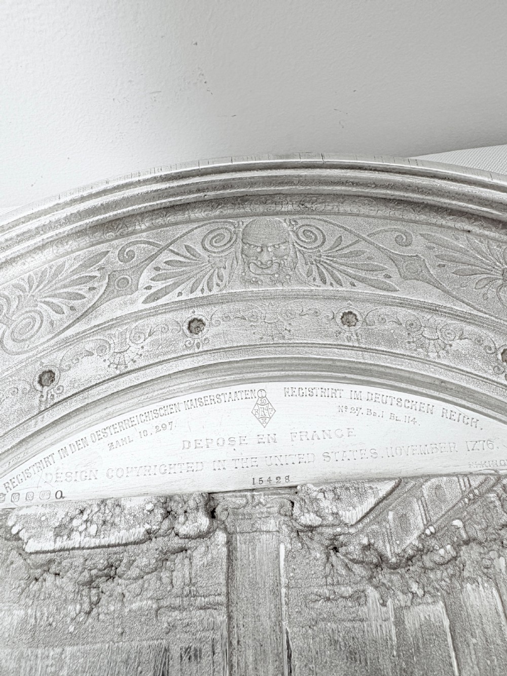 A circular silver plate electrotype charger featuring a detailed relief depiction of classical figures framed by ornate scrolled borders. View XI