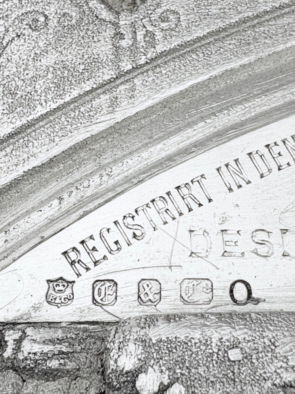 A circular silver plate electrotype charger featuring a detailed relief depiction of classical figures framed by ornate scrolled borders. View XII