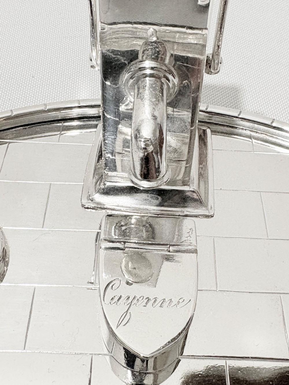 A Victorian silver-plated novelty cruet set featuring a central water pump pepper caster, a bucket salt cellar, and a milk churn mustard pot on a circular engraved tray. View II