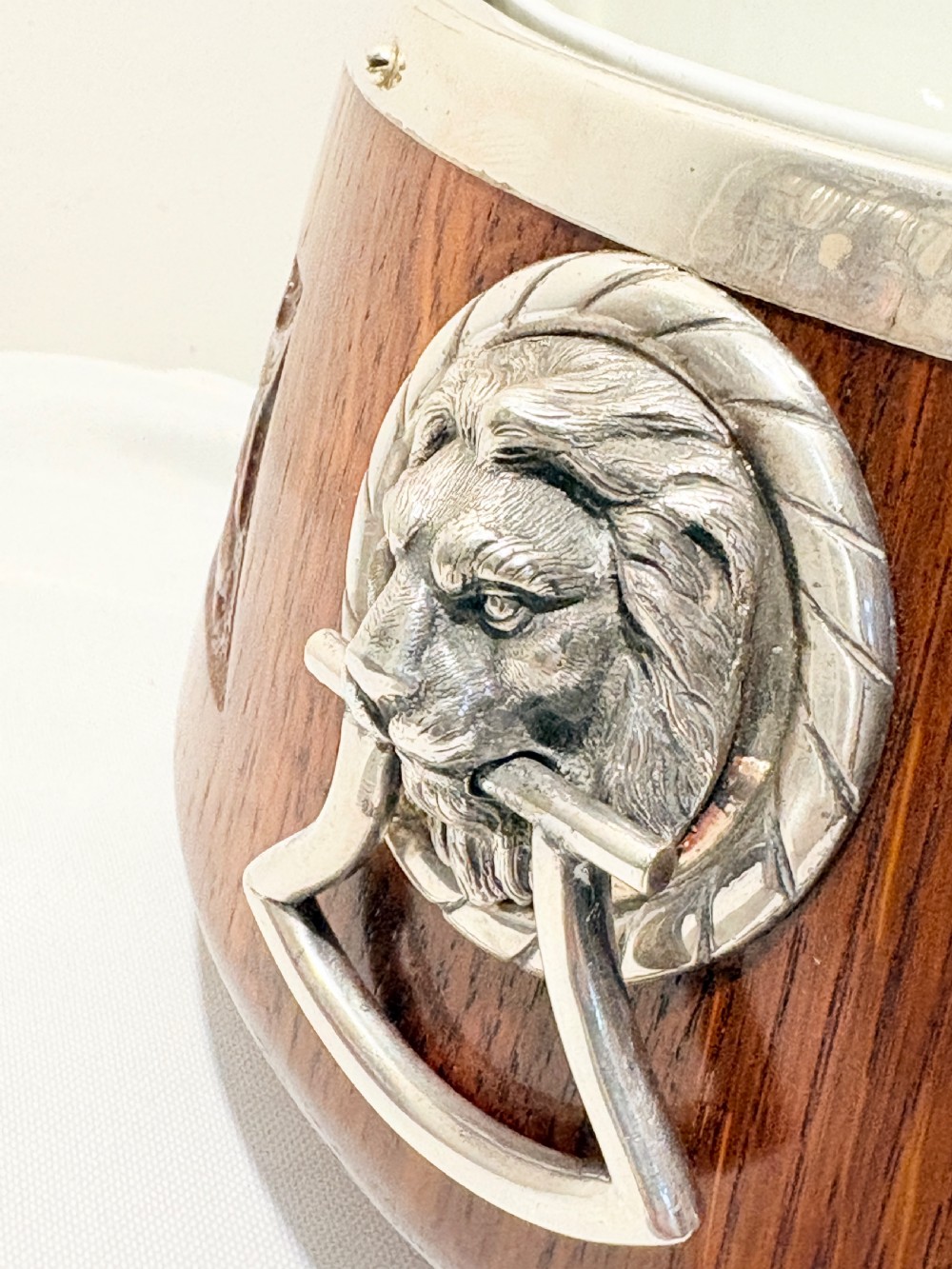 A late Victorian carved oak salad bowl with silver-plated rim, ball feet, and a white ceramic liner, featuring an ivy leaf carved band around the exterior. View II