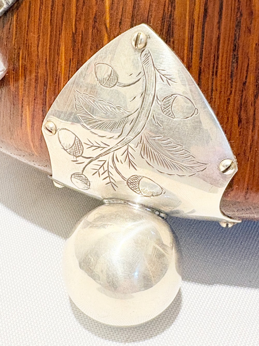 A late Victorian carved oak salad bowl with silver-plated rim, ball feet, and a white ceramic liner, featuring an ivy leaf carved band around the exterior. View III