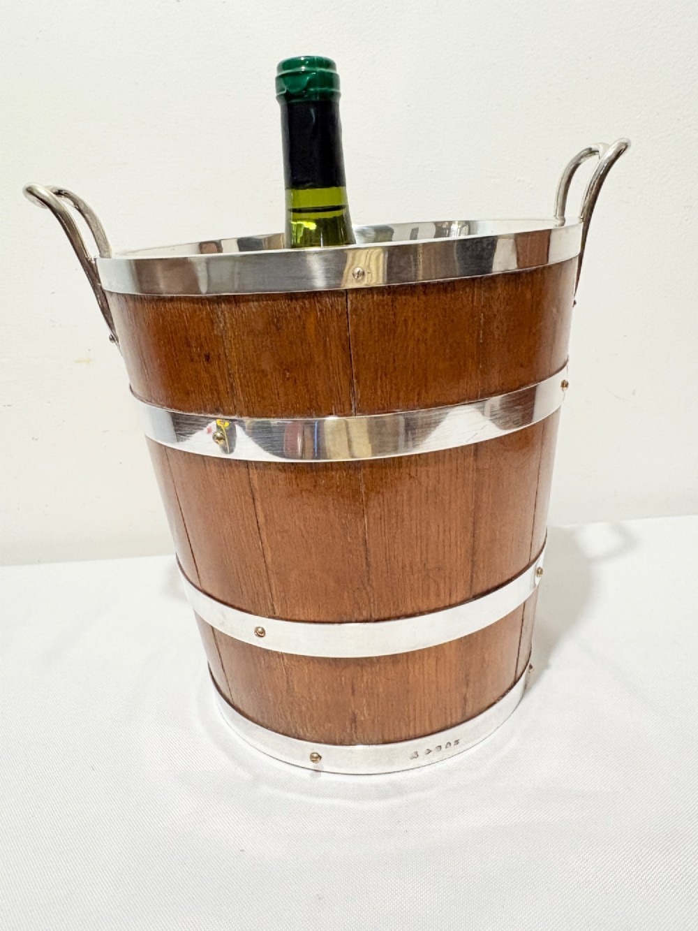 An antique coopered oak wine bucket featuring polished silver-plated bands, twin side handles, and a removable metal liner. View II