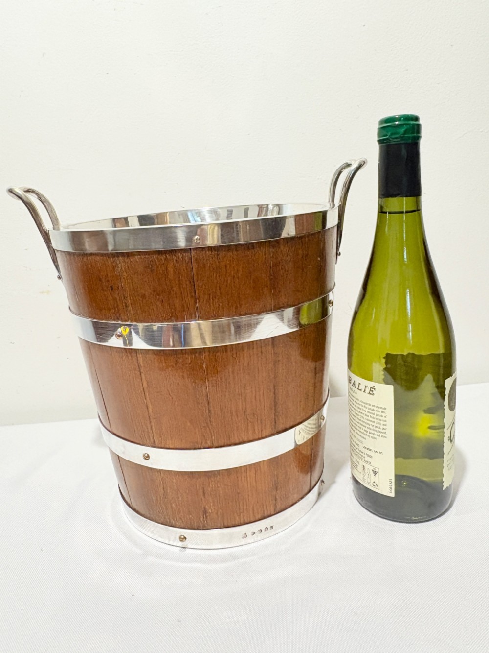 An antique coopered oak wine bucket featuring polished silver-plated bands, twin side handles, and a removable metal liner. View III