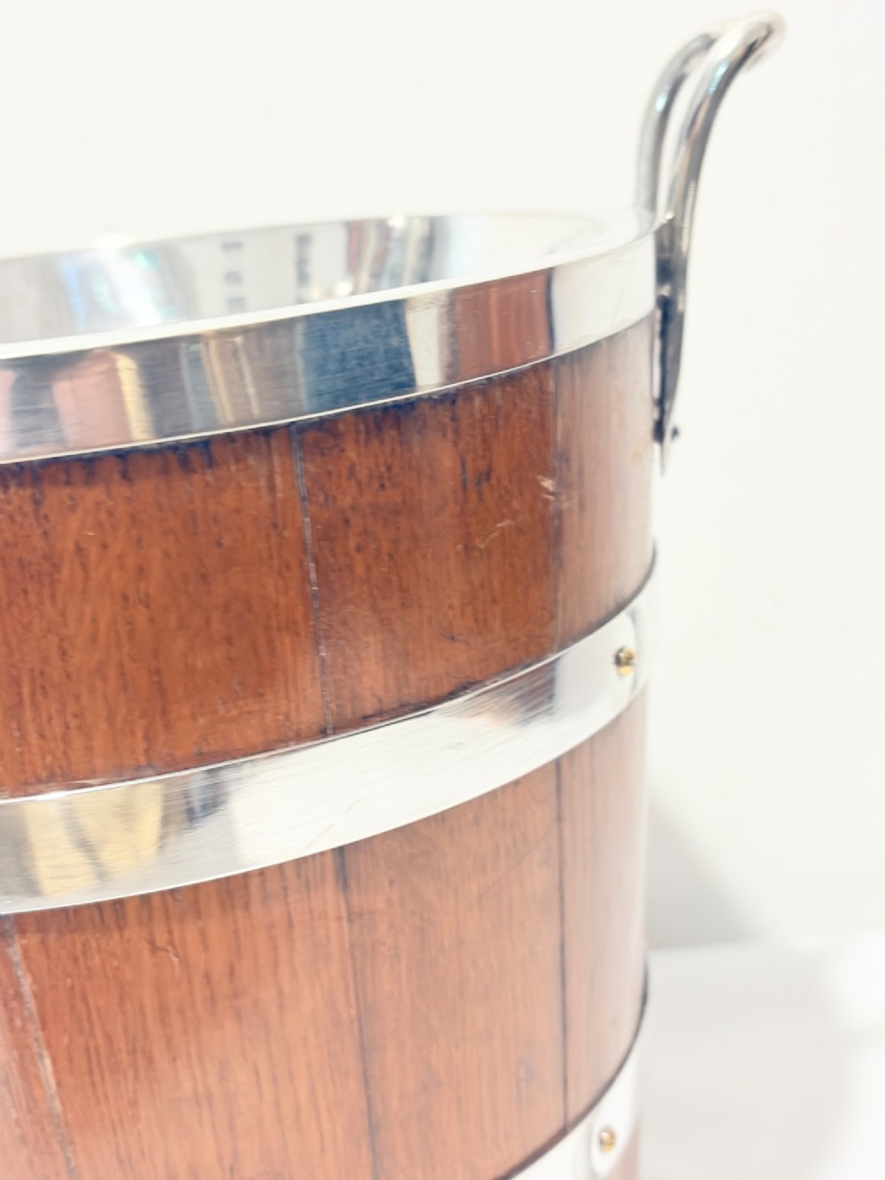 An antique coopered oak wine bucket featuring polished silver-plated bands, twin side handles, and a removable metal liner. View IV