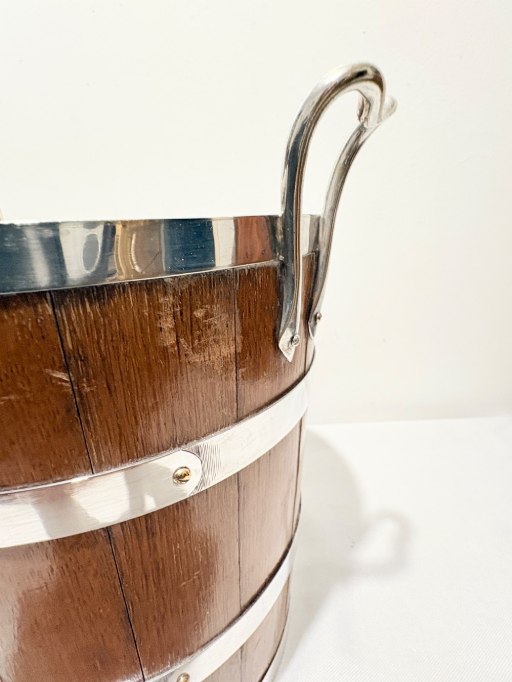 An antique coopered oak wine bucket featuring polished silver-plated bands, twin side handles, and a removable metal liner. View VII